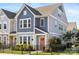 Charming two-story home featuring a black metal fence, blue siding, and a vibrant coral front door at 5008 Calvine Mill Way, Charlotte, NC 28205