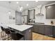 Modern kitchen with granite countertops, stainless steel appliances, and gray cabinets, and island with seating at 5008 Calvine Mill Way, Charlotte, NC 28205