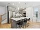 Well-equipped kitchen with stainless steel appliances, white countertops, and a stylish center island with seating at 5008 Calvine Mill Way, Charlotte, NC 28205