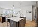 Spacious kitchen area featuring a large island with seating overlooking the bright and inviting living room at 5008 Calvine Mill Way, Charlotte, NC 28205