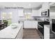 Bright kitchen features white cabinets, stainless steel appliances, and granite countertops at 5213 Crimson Kate Ln # 2007B, Charlotte, NC 28208