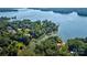 Scenic aerial view of a waterfront home nestled amongst lush greenery, providing privacy and stunning lake views at 5390 Hudson Rd, Clover, SC 29710
