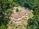 Unique home with a circular design, surrounded by lush greenery and a large wooden deck perfect for entertaining at 5390 Hudson Rd, Clover, SC 29710