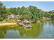 Stunning aerial view of the lakefront property with a private beach, dock, and lush surroundings at 5390 Hudson Rd, Clover, SC 29710