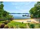 Scenic aerial view of the lakefront property featuring a sandy beach and lush greenery at 5390 Hudson Rd, Clover, SC 29710