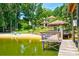 Sandy beach leading up to a home, featuring a covered dock and lake access at 5390 Hudson Rd, Clover, SC 29710