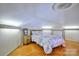 Attic bedroom featuring wood floors and a cozy lake-themed bed set under a unique dome ceiling at 5390 Hudson Rd, Clover, SC 29710