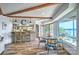 Bright dining area with lake views, wood beams and access to the kitchen bar at 5390 Hudson Rd, Clover, SC 29710