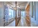 Upstairs hallway showing decorative wood trim and paneled doors plus a view of the eat in kitchen at 5390 Hudson Rd, Clover, SC 29710