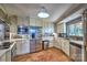 Well-lit kitchen with stainless steel appliances, tiled backsplash, and a terracotta-tiled floor at 5390 Hudson Rd, Clover, SC 29710