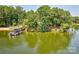 Scenic view of the lakefront with a private beach, dock, and lush green surroundings at 5390 Hudson Rd, Clover, SC 29710