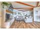 Cozy living room with a painted brick fireplace, wood beams and vinyl floors at 5390 Hudson Rd, Clover, SC 29710
