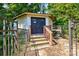 Charming outbuilding with a gated entrance and steps, offering privacy and potential for various uses at 5390 Hudson Rd, Clover, SC 29710