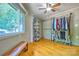 Bedroom with natural light, hardwood floors, clothes rack, and shoe storage at 5390 Hudson Rd, Lake Wylie, SC 29710