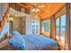 Bright bedroom features wood ceilings, fan, balcony access, and views of the water at 5390 Hudson Rd, Lake Wylie, SC 29710