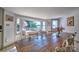 Cozy dining area featuring lake views, a long rustic table, and ample natural light at 5390 Hudson Rd, Lake Wylie, SC 29710