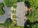 Aerial view showcasing a home's roof, parking, community gardens and lush trees at 5724 Cougar Ln, Charlotte, NC 28269