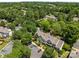 Aerial view highlighting a home amidst lush trees, parking areas, and community amenities at 5724 Cougar Ln, Charlotte, NC 28269