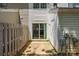 A backyard patio with sliding glass door, privacy fence, and utility connections offers an intimate outdoor space at 5724 Cougar Ln, Charlotte, NC 28269