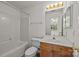 Bathroom featuring tub, mirror, lighting, and vanity with storage at 5724 Cougar Ln, Charlotte, NC 28269