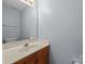 Modest bathroom with a single sink vanity and a large mirror at 5724 Cougar Ln, Charlotte, NC 28269