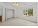 Bright bedroom featuring a ceiling fan, closet, and a view to the outdoors at 5724 Cougar Ln, Charlotte, NC 28269
