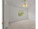 Bedroom with a window, fan, closet, and a door leading to the hallway at 5724 Cougar Ln, Charlotte, NC 28269