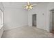 Carpeted bedroom with a ceiling fan, closet, and attached bathroom at 5724 Cougar Ln, Charlotte, NC 28269