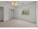 Bedroom featuring vaulted ceiling, large window with backyard views, and closet at 5724 Cougar Ln, Charlotte, NC 28269
