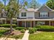 Traditional brick-front home with lush landscaping, mature trees, and inviting curb appeal at 5724 Cougar Ln, Charlotte, NC 28269