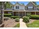 Traditional brick-front home with lush landscaping, mature trees, and inviting curb appeal at 5724 Cougar Ln, Charlotte, NC 28269