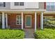 Charming townhome showcasing brick facade, inviting porch, and well-manicured landscaping at 5724 Cougar Ln, Charlotte, NC 28269