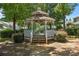 A gazebo sits nestled in a lush garden, offering a serene retreat for relaxation and outdoor enjoyment at 5724 Cougar Ln, Charlotte, NC 28269