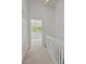 Upstairs hallway with carpet leading to bedroom with natural light at 5724 Cougar Ln, Charlotte, NC 28269