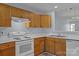 Well-lit kitchen with wooden cabinets, white countertops, and a sink at 5724 Cougar Ln, Charlotte, NC 28269