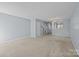Spacious living room with neutral carpet, ample natural light, and view of the staircase at 5724 Cougar Ln, Charlotte, NC 28269