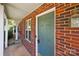 Charming porch featuring brick facade, lantern, and blue front door at 5724 Cougar Ln, Charlotte, NC 28269