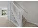 Carpeted staircase with white railings and built-in shelving, leading to the upper level at 5724 Cougar Ln, Charlotte, NC 28269