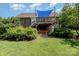 Backyard featuring house with large wooden deck with blue shade covering at 610 Mountain Pl, Albemarle, NC 28001