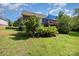 Well-maintained backyard featuring green grass, a blue sunshade, and some trees at 610 Mountain Pl, Albemarle, NC 28001