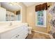 Neutral bathroom with a large vanity, tiled floor, and window with natural light at 610 Mountain Pl, Albemarle, NC 28001