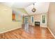 Open-concept living room with vaulted ceilings, fireplace, and luxury vinyl flooring at 610 Mountain Pl, Albemarle, NC 28001