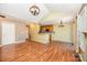 Spacious living room featuring wood floors, stylish lighting, and open flow to kitchen at 610 Mountain Pl, Albemarle, NC 28001