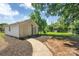 Detached garage featuring a stylish entrance surrounded by landscaped features and a cozy pathway at 6208 Karenstone Dr, Charlotte, NC 28215
