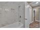 A remodeled bathroom features new tiled shower/bath with a built-in niche at 6208 Karenstone Dr, Charlotte, NC 28215
