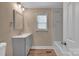 This remodeled bathroom features stylish vanity and updated shower with new tile at 6208 Karenstone Dr, Charlotte, NC 28215