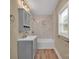 Updated bathroom features modern vanity and shower with stylish marble-look tile at 6208 Karenstone Dr, Charlotte, NC 28215