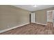 Bright bedroom features new flooring and a glimpse into an adjacent bathroom at 6208 Karenstone Dr, Charlotte, NC 28215