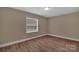 This cozy bedroom is well-lit with natural light and has stylish new floors at 6208 Karenstone Dr, Charlotte, NC 28215