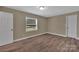 A cozy bedroom features neutral walls, new wood-look floors, and plenty of natural light at 6208 Karenstone Dr, Charlotte, NC 28215
